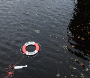 A life preserver thrown into a lake in Gothenburg, Sweden. Photo by Lukas Juhas on Unsplash