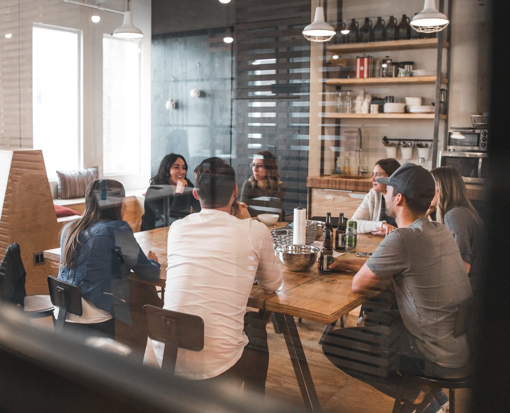Photo: Group of people sitting around a table by bantersnaps on Unsplash