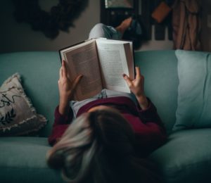 Woman holding an open book Photo by Matias North on Unsplash