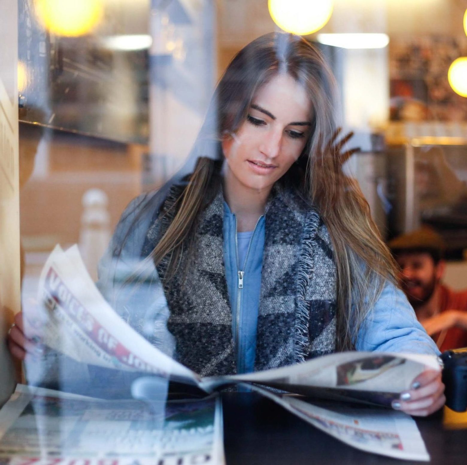Woman reading a newspaper Keenan Constance on Unsplash